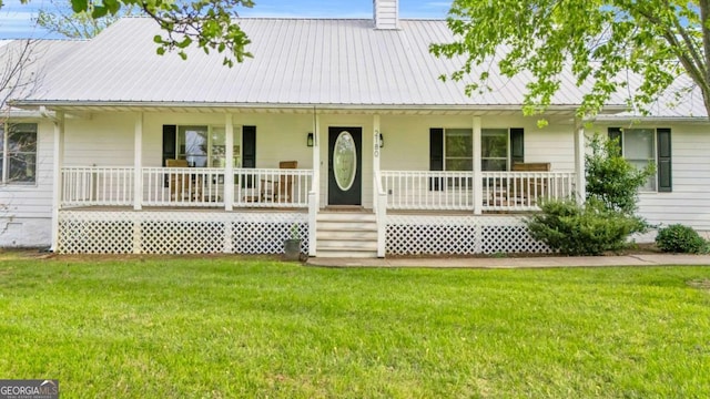 2180 Pine Lake Rd, Hiawassee, GA 30546 - view of front of house featuring a chimney, a front lawn, metal roof, and covered porch