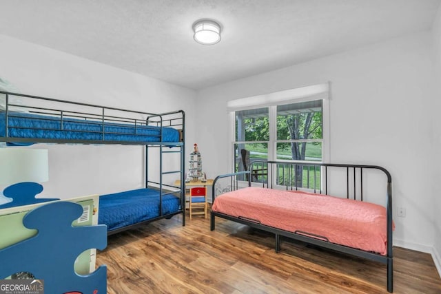 2180 Pine Lake Rd, Hiawassee, GA 30546 - bedroom featuring baseboards and wood finished floors