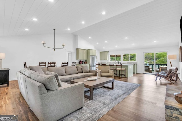 2180 Pine Lake Rd, Hiawassee, GA 30546 - living room with recessed lighting, a chandelier, wood finished floors, and high vaulted ceiling