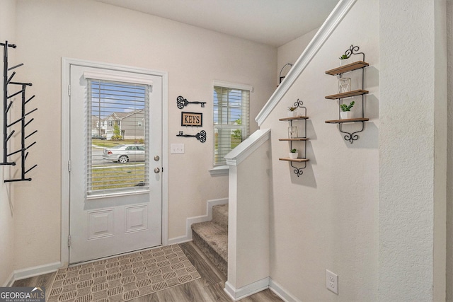 231 Limestone Cir, Conyers, GA 30013 - doorway featuring stairs, wood finished floors, and baseboards