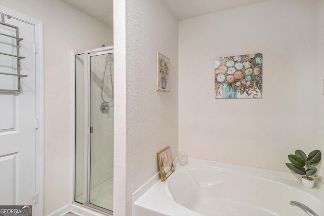 231 Limestone Cir, Conyers, GA 30013 - bathroom featuring a bath and a stall shower
