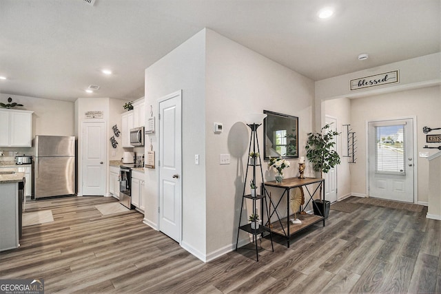 231 Limestone Cir, Conyers, GA 30013 - entryway featuring baseboards, wood finished floors, and recessed lighting