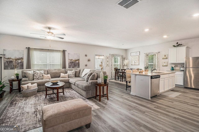 231 Limestone Cir, Conyers, GA 30013 - living area featuring recessed lighting, light wood-type flooring, visible vents, and a ceiling fan