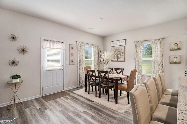 231 Limestone Cir, Conyers, GA 30013 - dining area with wood finished floors, a wealth of natural light, baseboards, and visible vents