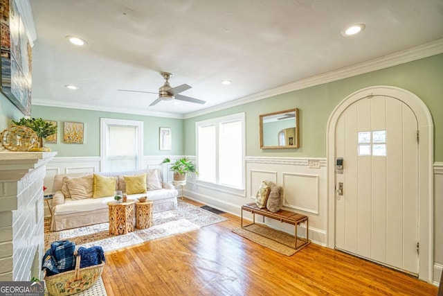 98 Chappell Rd NW, Atlanta, GA 30314 - living area featuring crown molding, wood finished floors, a wainscoted wall, and a ceiling fan