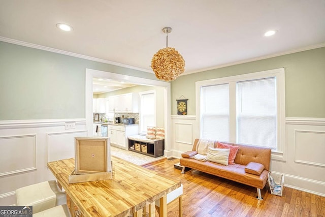 98 Chappell Rd NW, Atlanta, GA 30314 - living area featuring crown molding, wainscoting, light wood-style floors, and a decorative wall