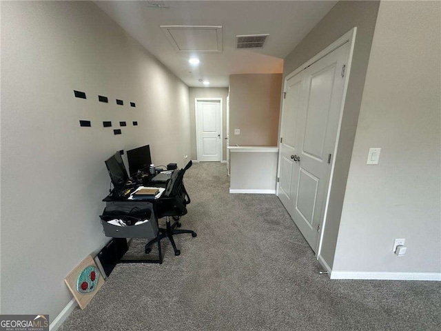 office area with attic access, baseboards, visible vents, and carpet