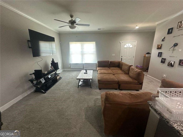 carpeted living room featuring a ceiling fan, baseboards, and crown molding