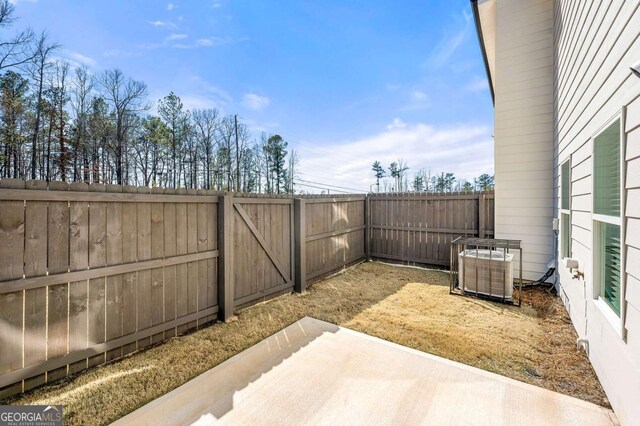 view of patio with cooling unit and a fenced backyard