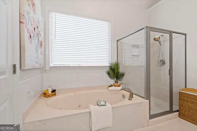 bathroom with a tub with jets and a shower stall