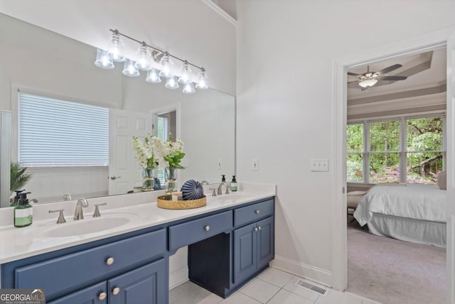 bathroom with double vanity, a ceiling fan, visible vents, tile patterned flooring, and a sink