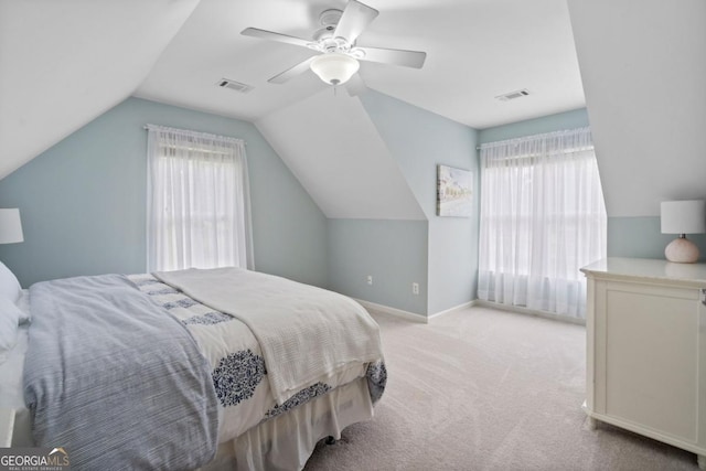 carpeted bedroom with a ceiling fan, visible vents, and multiple windows