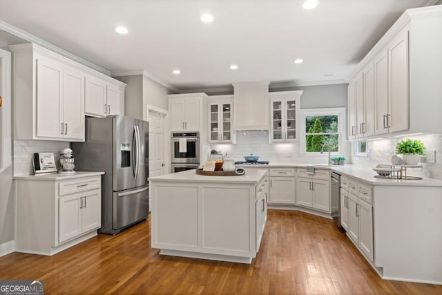 kitchen featuring crown molding, appliances with stainless steel finishes, and tasteful backsplash