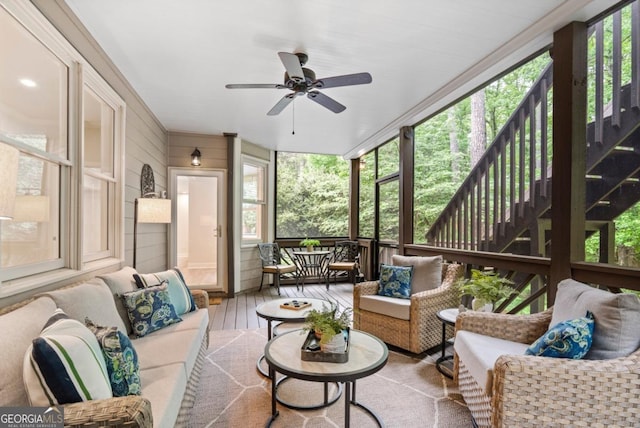 sunroom with an outdoor living space and a ceiling fan
