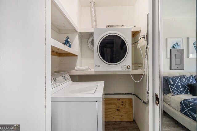 215 Piedmont Ave NE Unit 2210, Atlanta, GA 30308 - laundry area with wood finished floors, laundry area, and washer / clothes dryer