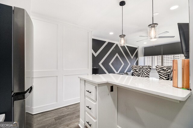 215 Piedmont Ave NE Unit 2210, Atlanta, GA 30308 - kitchen with ceiling fan, wood finished floors, white cabinets, and freestanding refrigerator