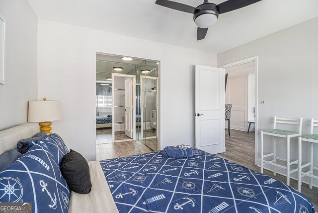 215 Piedmont Ave NE Unit 2210, Atlanta, GA 30308 - bedroom featuring ceiling fan, ensuite bath, and wood finished floors