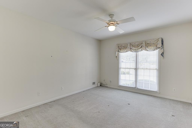 unfurnished room featuring a ceiling fan, carpet, and baseboards