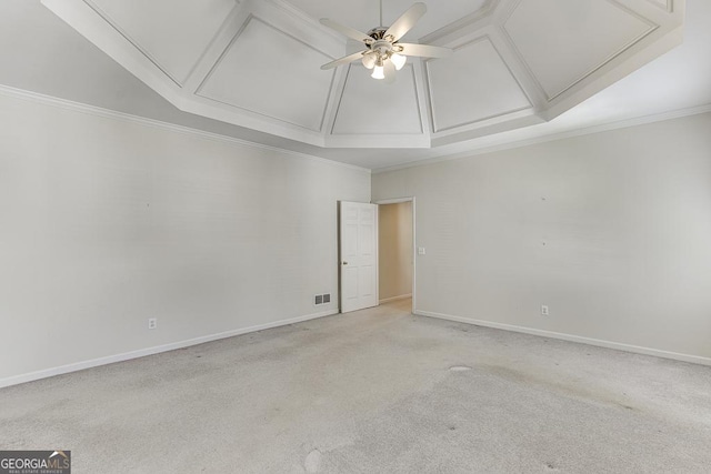 unfurnished room with attic access, ceiling fan, light carpet, baseboards, and ornamental molding