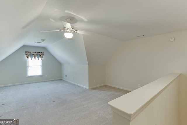 bonus room featuring lofted ceiling, light carpet, ceiling fan, and baseboards