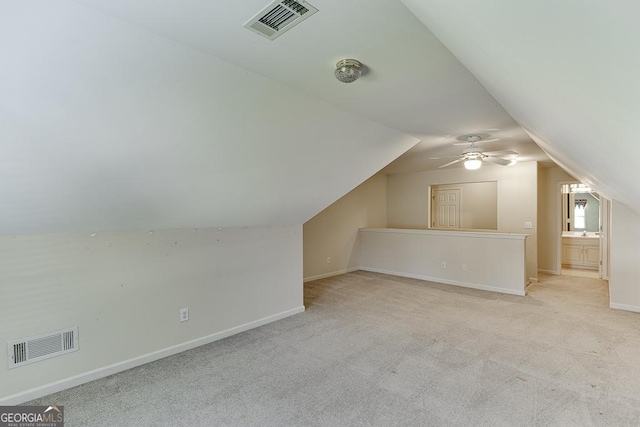 additional living space featuring carpet, lofted ceiling, baseboards, and a ceiling fan