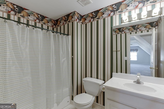 full bathroom with toilet, vanity, and wallpapered walls