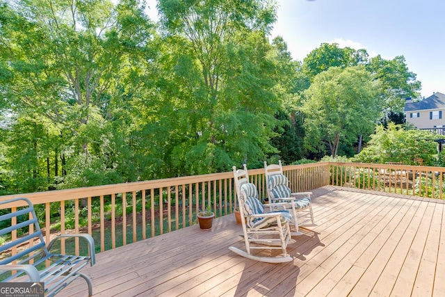 deck featuring view of scattered trees