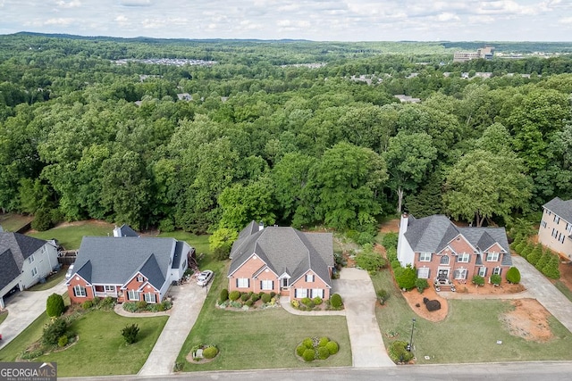 aerial perspective of suburban area featuring a heavily wooded area