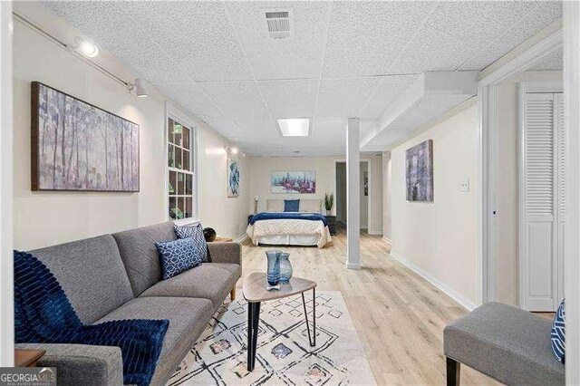 bedroom featuring light wood finished floors, baseboards, and visible vents