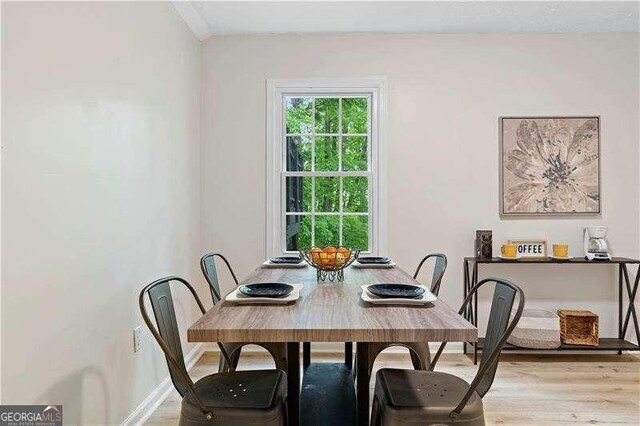 dining room featuring baseboards and wood finished floors