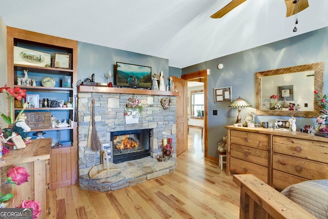 bedroom featuring wood finished floors and a fireplace