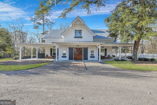 view of property featuring a carport, aphalt driveway, and fence