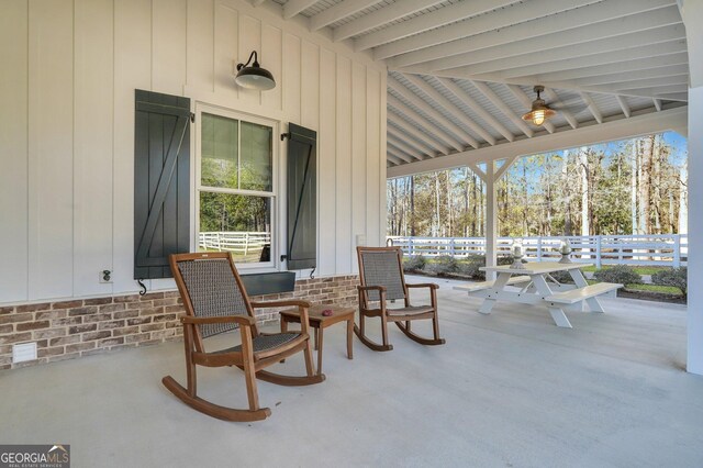 view of patio / terrace with ceiling fan and a porch