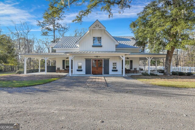 view of building exterior with driveway and fence