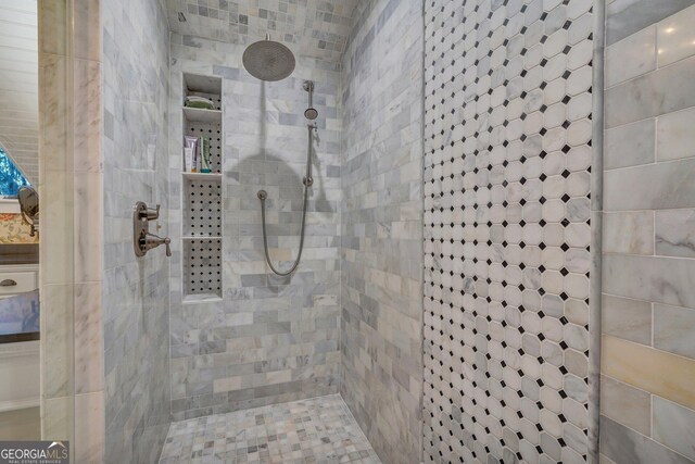 full bath featuring tiled shower
