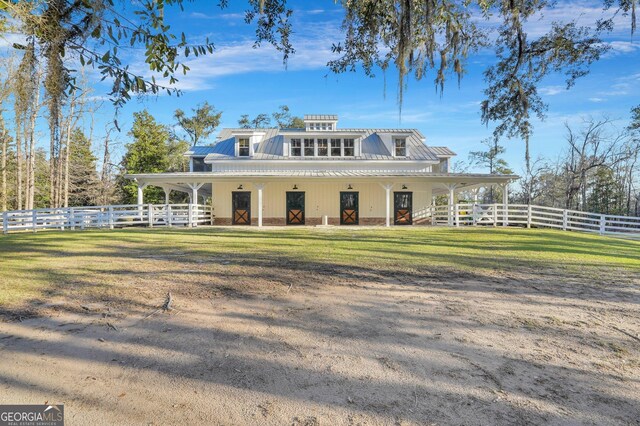 back of house featuring fence and metal roof