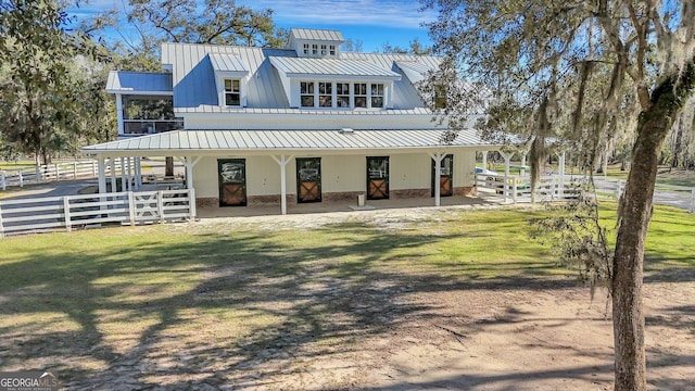 exterior space featuring metal roof, a standing seam roof, and fence