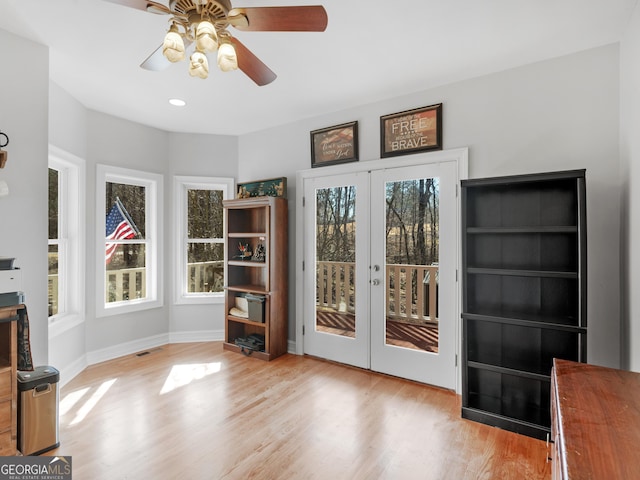 interior space with wood finished floors, a ceiling fan, french doors, and recessed lighting