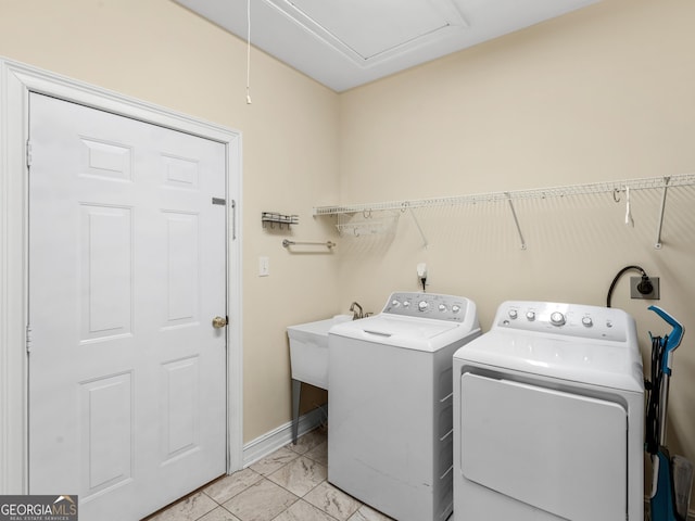 laundry room with light marble finish flooring, independent washer and dryer, baseboards, and attic access