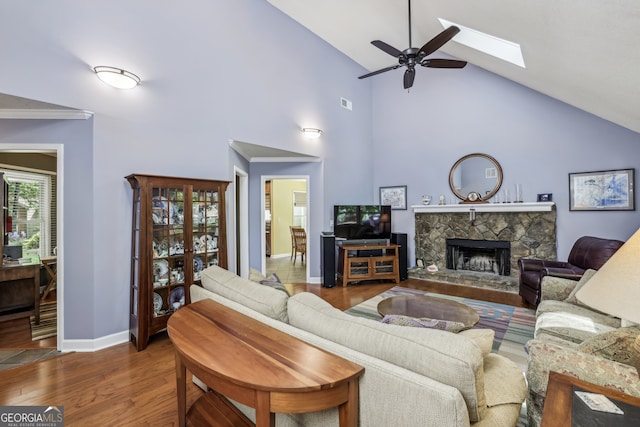 1390 Barclay Dr, Lawrenceville, GA 30043 - living room with baseboards, a skylight, wood finished floors, ceiling fan, and a fireplace