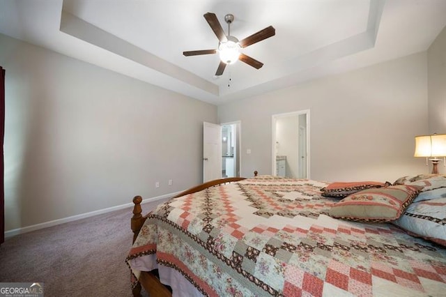 bedroom with a tray ceiling, baseboards, carpet, and a ceiling fan