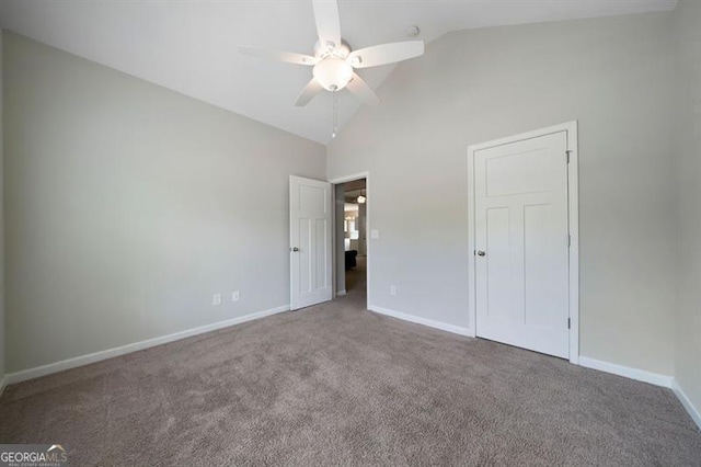 unfurnished bedroom with lofted ceiling, carpet, baseboards, and ceiling fan
