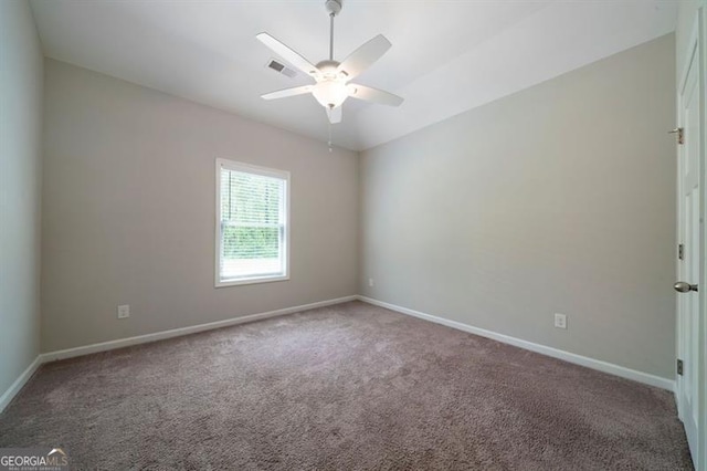 carpeted empty room featuring baseboards and ceiling fan
