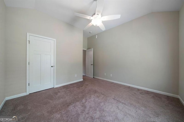 unfurnished bedroom featuring lofted ceiling, carpet flooring, baseboards, and ceiling fan
