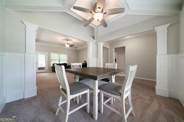 dining area featuring decorative columns, carpet, and a ceiling fan