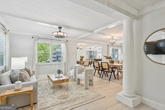 285 Lakemoore Dr NE Unit A, Atlanta, GA 30342 - living room featuring decorative columns, wood finished floors, a wealth of natural light, and an inviting chandelier