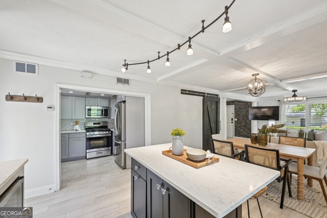 285 Lakemoore Dr NE Unit A, Atlanta, GA 30342 - kitchen featuring light wood-type flooring, visible vents, appliances with stainless steel finishes, and decorative backsplash