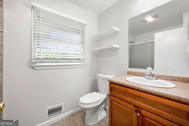 3050 Rebecca Dr SW, Atlanta, GA 30311 - bathroom with vanity, a shower with shower door, and wood finished floors