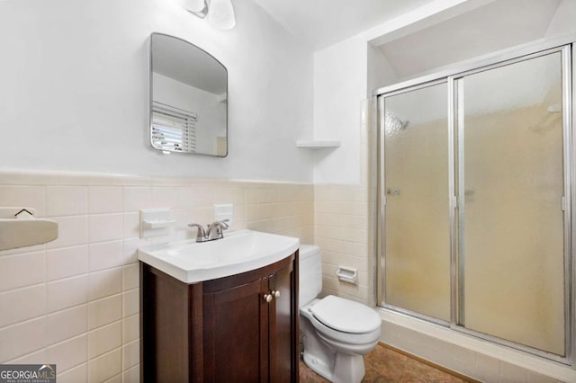 3050 Rebecca Dr SW, Atlanta, GA 30311 - full bathroom with vanity, a shower stall, tile walls, and a wainscoted wall