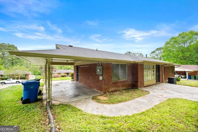 3050 Rebecca Dr SW, Atlanta, GA 30311 - view of side of property featuring brick siding, a yard, driveway, and an attached carport